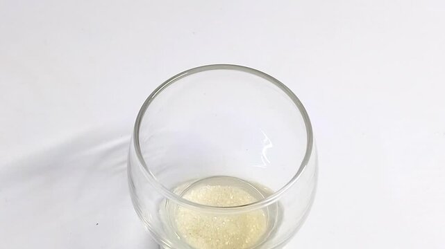 pouring sugar into the glass repeatedly - Powered by Adobe