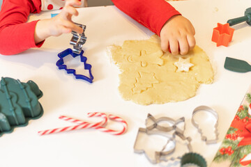 Children enjoy baking cookies with colorful cutters during holiday preparations at home