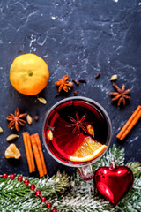 Christmas mulled wine with spices in cup on dark background