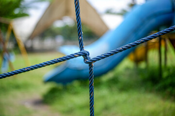 Closeup of blue ropes tied in a knot at a park playground setting