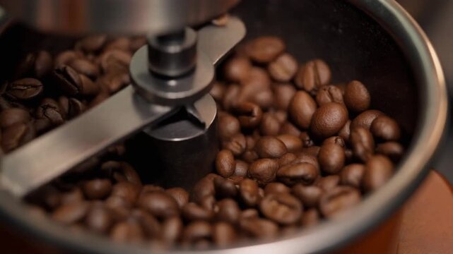 Close-up coffee beans footage in the grinder machine 
