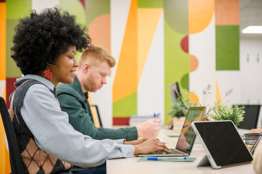 Diverse professionals collaborating in a modern coworking office space