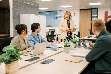 Senior working woman leading a diverse business meeting