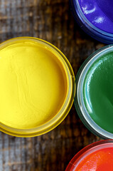 cans gouache on a wooden background