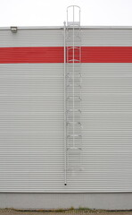 A vertical fire escape on a gray metal wall