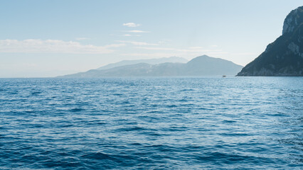 Capri, Italy - 04.29.2025: Seascape from the highest point of the island with a view of the sea and islands. There is haze in the distance.