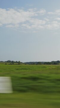 sunny summer day farmers green field forest background landscape passenger side window pov vertical panorama 4k