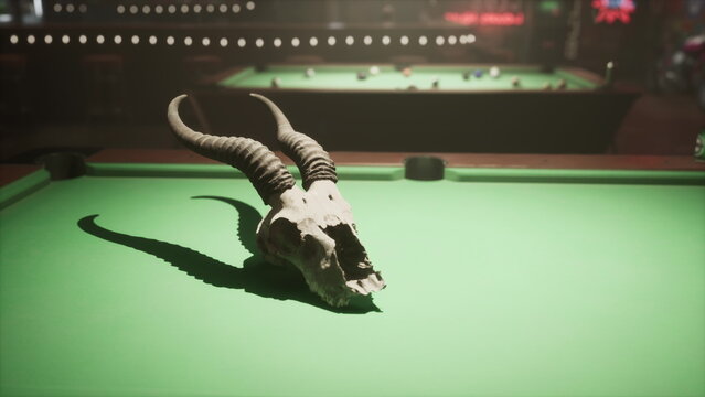 A bull skull rests on a pool table in a dimly lit room.
