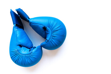 Blue boxing gloves arranged on white background with strong negative space; sleek fitness gear image for training guides, gym ads and healthy, disciplined lifestyle messaging.