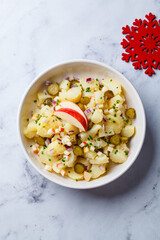 Traditional German potato salad with pickles, onions and apple.