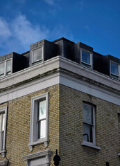 Residential brick building facade under clear blue sky