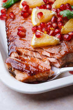 Christmas salmon in pomegranate juice with orange and pomegranate seeds.