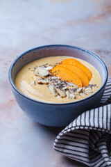 Persimmon smoothie bowl with chia seeds and nuts.