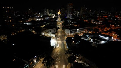 Aerial night view of a city with illuminated streets and buildings. Urban, architecture, night. Perfect for travel, tourism, commercial themes.