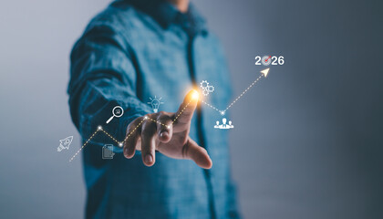 A person touching a virtual graph with icons and the year 2026, representing business growth, innovation, strategic planning, data analysis and achieving future goals