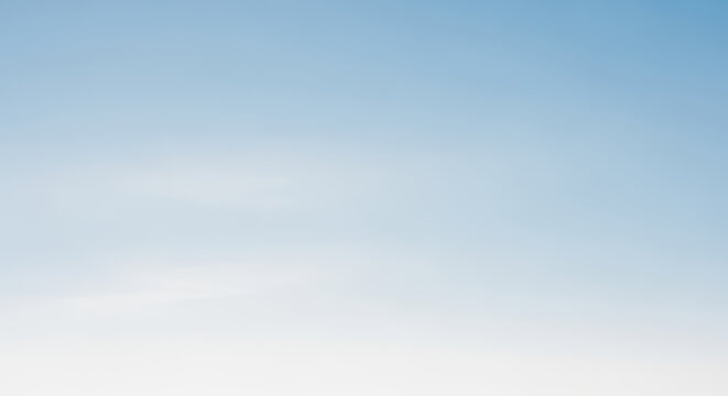 A Serene Gradient of Blue Fading Into a Pure White Sky Backdrop
