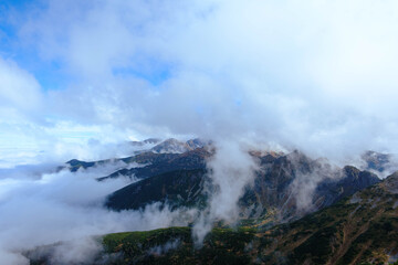 Mists and clouds hovering over the mountains.