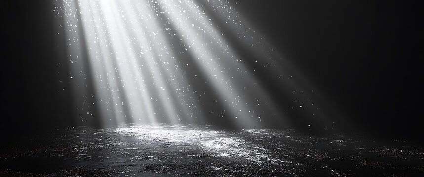 Dramatic light rays illuminating dust particles on a dark textured surface beams spotlight