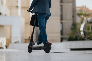 A person on an electric scooter glides through an urban setting, dressed in jeans and a blazer. The...
