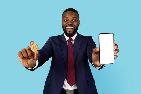 Cryptocurrency App. African Businessman Showing Golden Bitcoin Coin And Blank Smartphone With White Screen At Camera, Black Male Entrepreneur Recommending Online Trading Application, Collage, Mockup