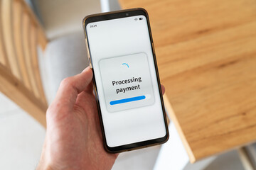 Processing payment message on smartphone screen. Paying with your phone.