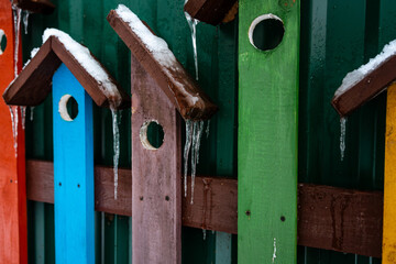 Winter decor in the form of assorted boards birdhouses with icicles