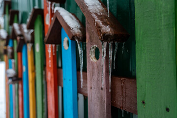 Winter decor in the form of assorted boards birdhouses with icicles