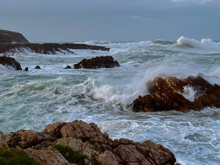 Powerful ocean waves crashing against rocky shore
