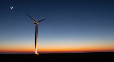 A wind turbine spinning against a starry night sky with a crescent moon and a glowing horizon.