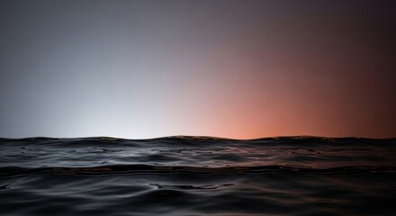 A serene ocean with gentle waves under a hazy sky at sunset.