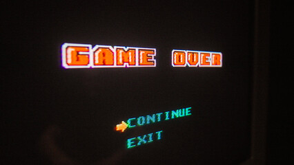 Close-up score display of an old school pixel game on a CRT TV. Game over screen
