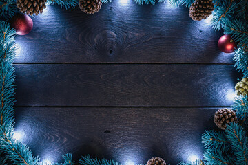 Rustic wooden background with festive christmas garland and lights