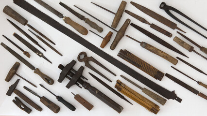 Large display of vintage woodworking tools arranged on a wall. Rustic atmosphere ideal for craft, heritage, workshop and artisan storytelling.