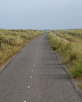 long cycle path along the dike on the dutch north sea