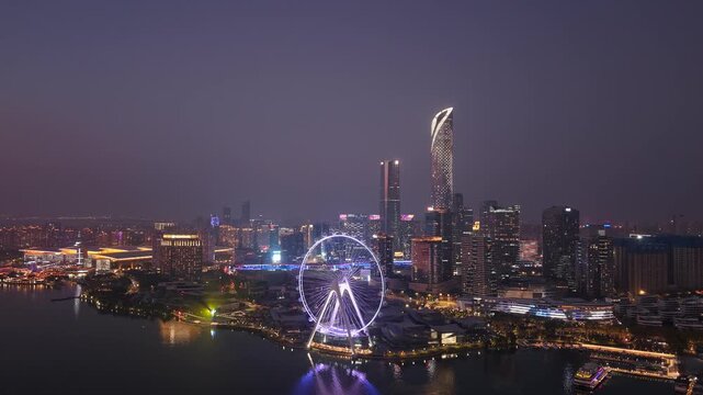 Aerial time-lapse of the night view skyline of the Ferris wheel in Jinji Lake, Suzhou, Jiangsu Province, China.