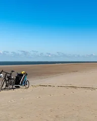 Acrylglasbilder Nordsee parked bicycles on the north sea beach  © Ulrich