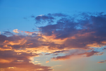 Dramatic sky with beautiful pink and orange clouds at sunset.