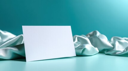 A pristine, blank card rests elegantly on soft satin fabric, creating a refined and inviting presentation perfect for a range of elegant events or special occasions.