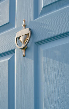Close-up of door knocker on blue front door