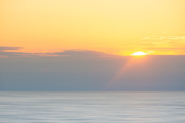 Sun setting above calm Madaket Beach