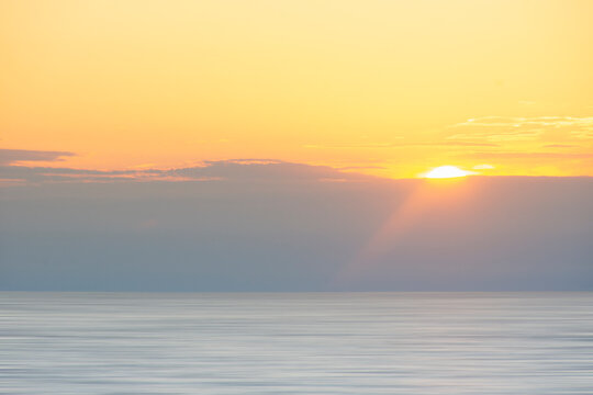 Sun setting above calm Madaket Beach