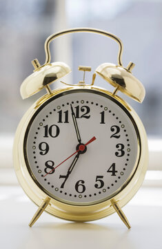 Old fashioned alarm clock on nightstand