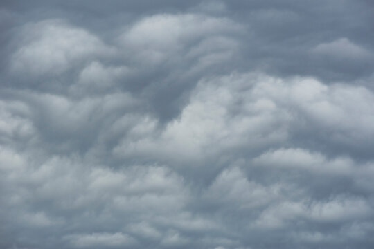 White storm clouds against blue sky