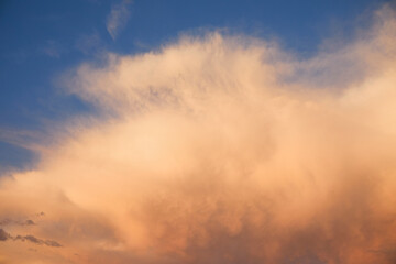 Puffy clouds on sky at sunset