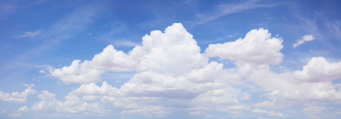 Puffy white clouds on blue sky