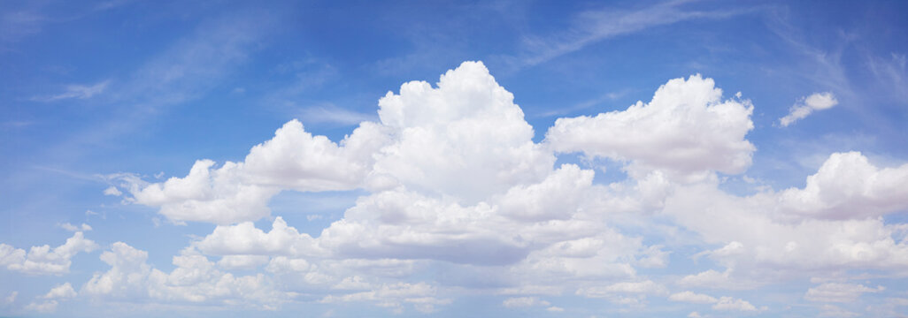 Puffy white clouds on blue sky