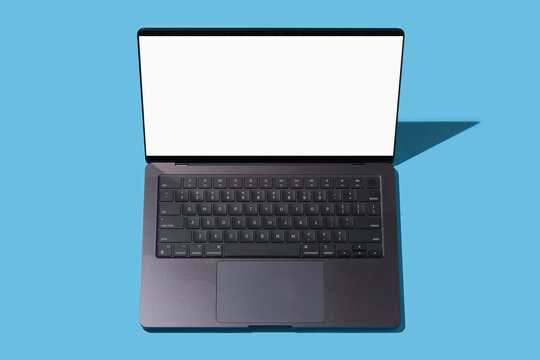 High angle view of open laptop on blue background