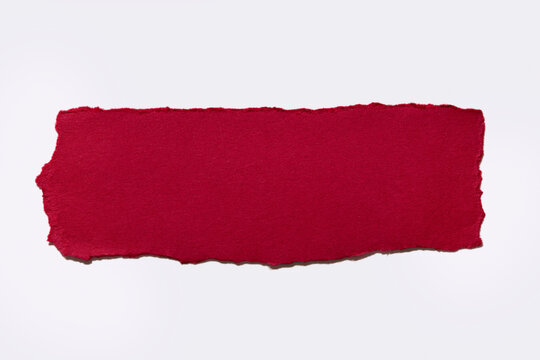 Torn red paper on white background