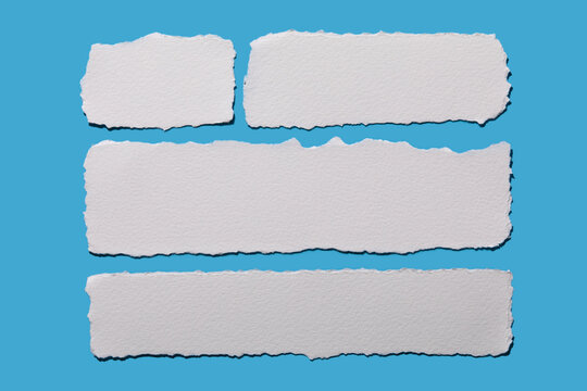 Strips of white torn paper on blue background