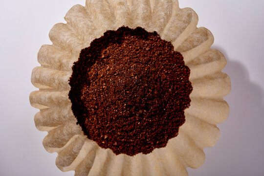 Overhead view of grounded coffee in paper filter